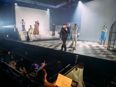 Stage Manager on stage speaking to conductor during a technical rehearsal